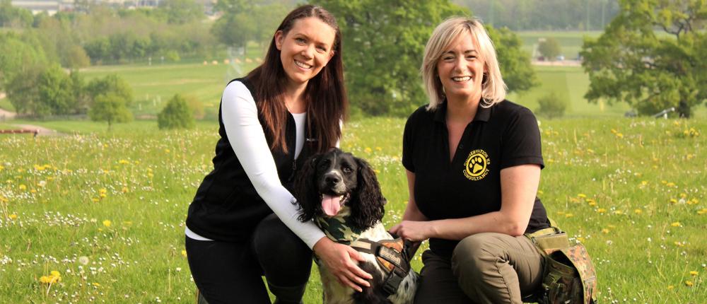 Two Handlers With Dog
